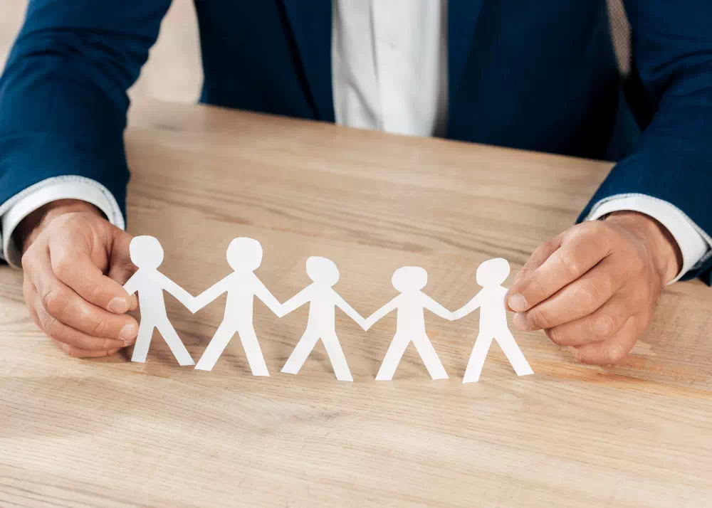 close-up-hands-holding-paper-people