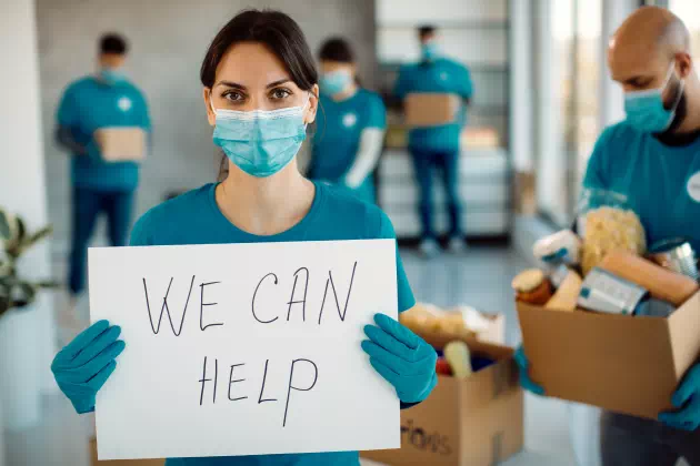 young-woman-working-as-volunteer-holding-placard-with-we-can-help-inscription